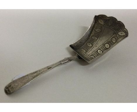 A silver caddy spoon with engraved shovel-shaped bowl. Birmingham 1813. By IT.  Approx. 8 grams. Est. £30 - £40.