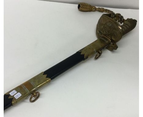 An old Naval sword in scabbard. Est. £80 - £120.