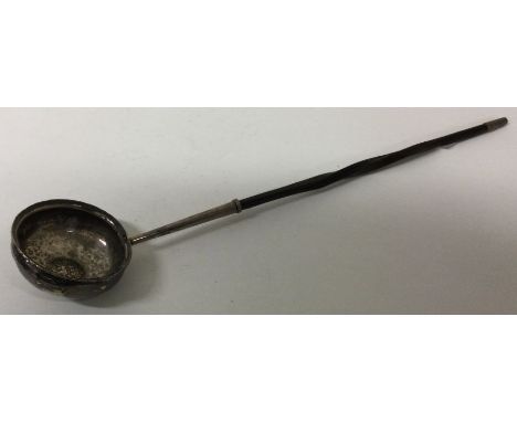 A 19th silver toddy ladle with early coin to centre. Approx. 39 grams. Est. £30 - £50.