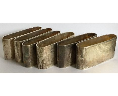 A set of six engine turned cased silver napkin rings. London 1935.  By John Collard Vickery. Approx. 236 grams. Est. £300 - £