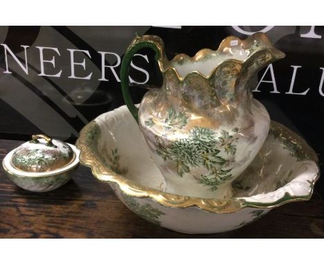 A large gilt jug and basin set. Est. £30 - £40.