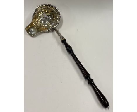 A large 19th Century silver and wood handled toddy ladle. Approx. 70 grams. Est. £60 - £80.