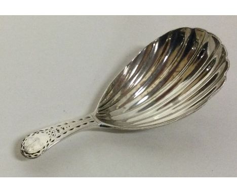 A silver caddy spoon with bright-cut handle and fluted bowl. London 1784. By CH.  Approx. 9 grams. Est. £30 - £40.