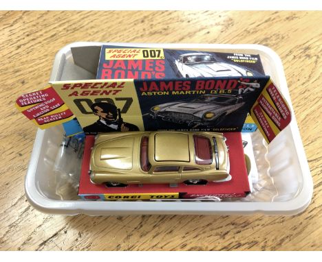 Corgi Toys Aston Martin DB5 from the James Bond film 'Goldfinger'. Re-issue of complete set in mint condition. Together with 