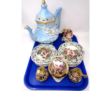 A tray containing assorted Italian ceramics including flower encrusted teapot, a set of seven cherub wall plaques, salt shake