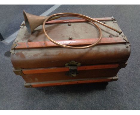 A tin trunk and a copper and brass hunting horn.