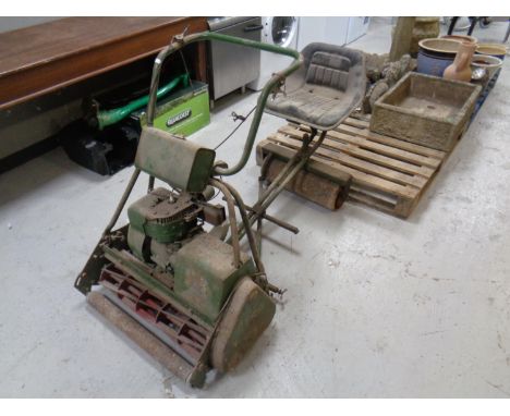 A vintage Atco self drive petrol mower with seat attachment, roller and grass box 