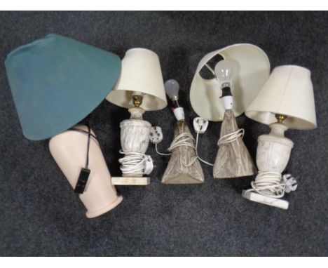 A box containing a pair of pottery table lamps, a pair of alabaster table lamps and a further ceramic table lamp.