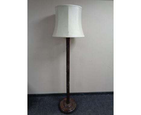 An oriental style carved beechwood standard lamp with shade