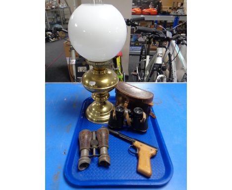 A tray containing a Diana model 2 air pistol, two sets of field glasses (one in leather case) together with a brass oil lamp 