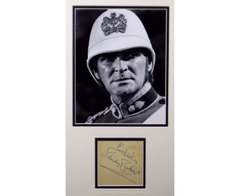 STANLEY BAKER autograph with 'Best Wishes' on paper and framed together with a still photograph print of the actor in Zulu ga