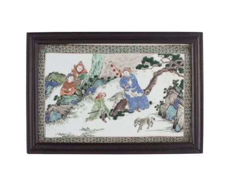 FAMILLE VERTE PORCELAIN PLAQUEKANGXI PERIOD painted with two figures engaged in a conversation in a rocky landscape, watched 
