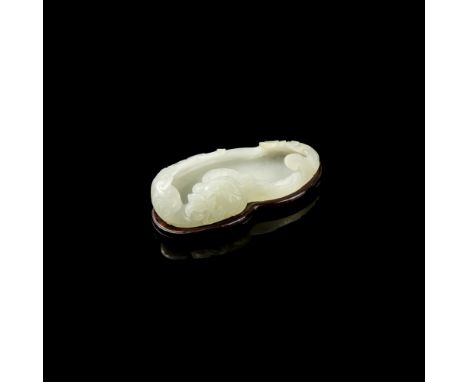 CELADON JADE 'GOOSE' BRUSH WASHERcarved in the form of a goose swimming in rippling water, clasping a peach sprig in its beak