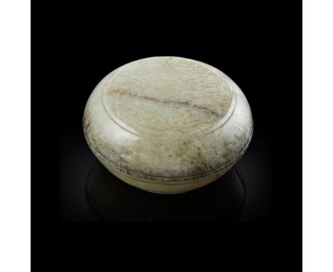 CELADON JADE CIRCULAR BOX AND COVERQING DYNASTY, 19TH CENTURY the cover carved in low relief with a medallion enclosing a lar