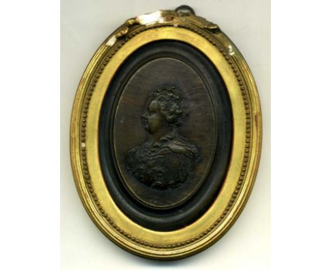 Anne, a uniface oval portrait medallion in translucent pressed horn, after Jean Obrisset but unsigned, portraying the crowned