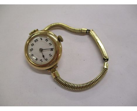 An early 20th century ladies' 9ct gold enamel dial wristwatch on a later plated snake chain bracelet