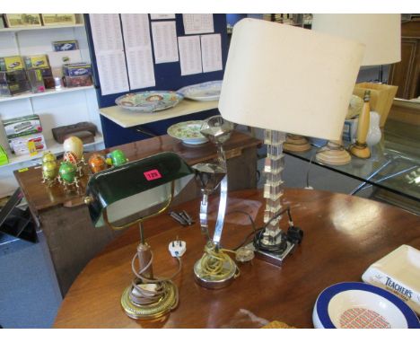 Three lamps to include a brass desk light with a green glass shade, a Perspex example and a chrome lamp