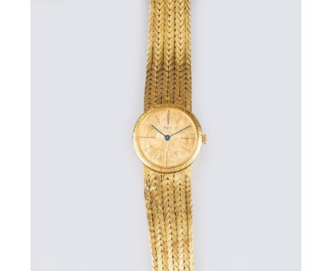   Piaget  gegr. 1874  Gold Damen-Armbanduhr  18 kt. GG, gest. Handaufzug. Ziseliertes Gold-Zifferblatt, Indizes, Blauzeiger, 