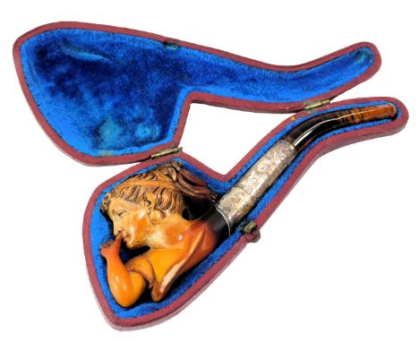 A silver collared and amber Meerschaum pipe, depicting a lady taking snuff, in fitted case, 14cm wide.