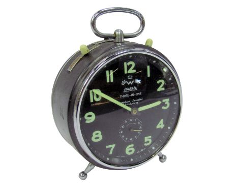A 1960s Wehrle three in one steel cased alarm clock, the black circular dial bearing glow in the dark Arabic numerals, subsid