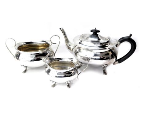 A George VI  silver three piece tea set, comprising teapot, milk jug and sucrier, the teapot with ebonised handle and knop, o