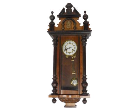 A Vienna walnut cased wall clock, the white circular enamel dial bearing Roman numerals for Junghans, eight day movement, cas