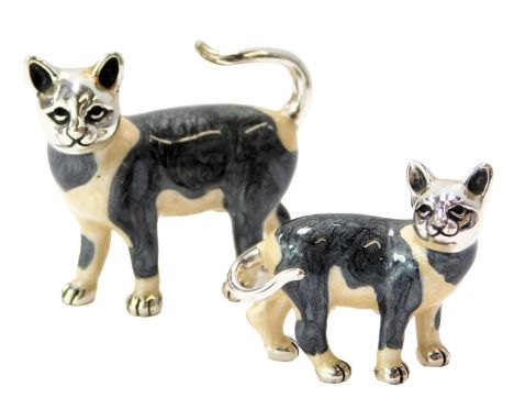 Two silver and enamel figures modelled as black and white cats, stamped 925, 4cm high and 2.7cm high. 