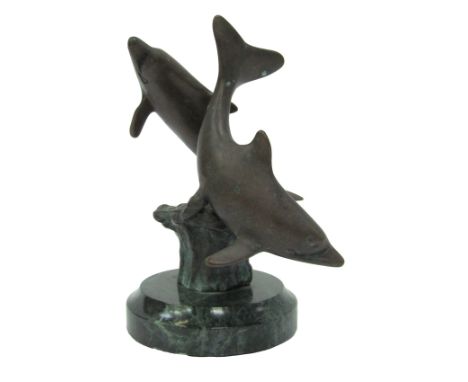 A 20thC bronze figure group modelled as two dolphins riding wave, on a green marble base, unsigned, 13.5cm high.