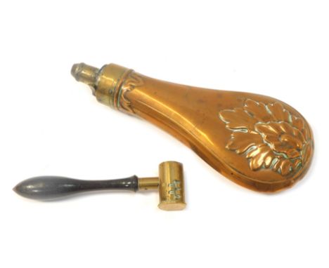 A copper and brass powder flask, raised leaf decoration, 21cm high, and a shot measure, with turned wooden handle. (2)