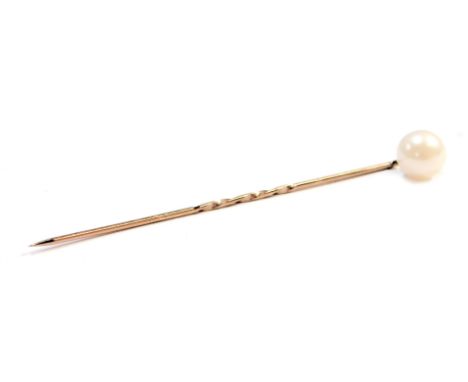 A cultured pearl topped stick pin, on a yellow metal back, unmarked, 6cm high, boxed.
