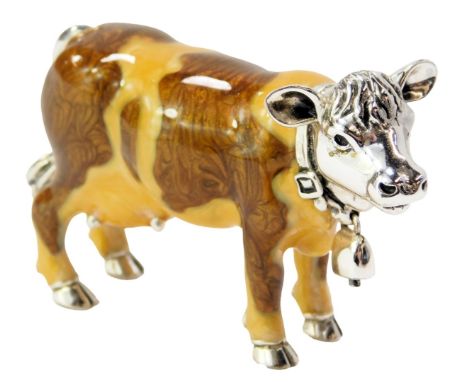 A silver and enamel figure modelled as a cow, with hanging bell collar, stamped 925, 4.5cm high. 