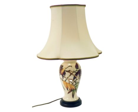 A Moorcroft pottery lamp base decorated in the Sumac pattern, of baluster form, with shade, 62cm high overall. 
