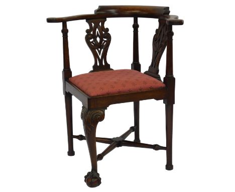 A 20thC Chippendale mahogany corner chair, raised on leaf carved cabriole legs, on ball and claw feet, united by an X stretch
