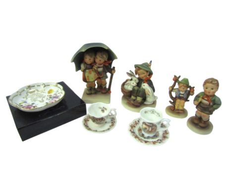Four Hummel figures, comprising Playmates, Stormy Weather, Apple Tree Boy, and Trumpet Boy, together with two Royal Doulton B