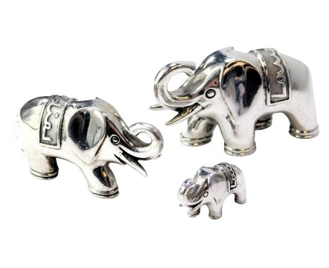 A graduated set of three silver elephants, each with trunk raised, wearing rug for Landier, each stamped 925, 4cm high, 3cm h