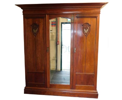 A Victorian walnut compactum wardrobe, the out swept pediment with dentil moulding, above a central door with bevelled glass 