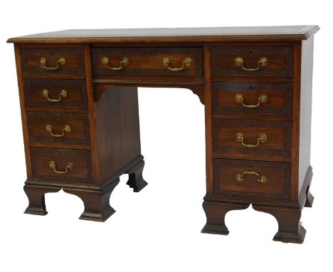 A mahogany twin pedestal desk, with a gilt tooled green leather top, above a central drawer and twin pedestals, each of four 
