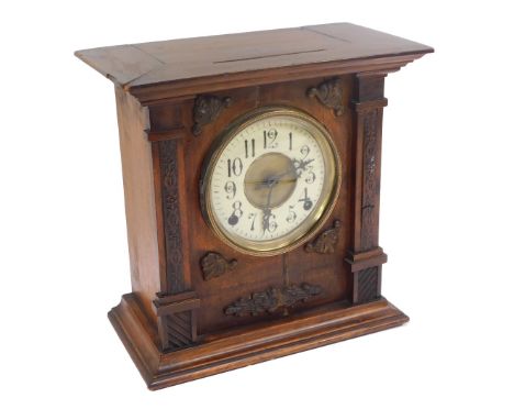 A Victorian oak cased mantel clock, circular brass dial with enamel chapter ring, bearing Arabic numerals, movement with coil
