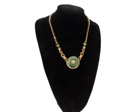 An 18ct gold jade necklace, the circular disc design with a round brilliant cut diamond in rub over setting, with a carved an