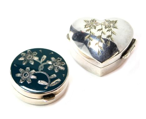 An Elizabeth II silver pill box, of heart shaped form, the lid bright cut decorated with flowers, London 1994, together with 