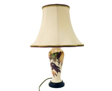 A Moorcroft pottery lamp base decorated in the Sumac pattern, of cylindrical tapering form, with shade, 48cm high overall. 