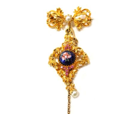 An Edwardian 18ct gold brooch, with pierced filigree type design and an enamel blue rose centre, set with garnets and seed pe