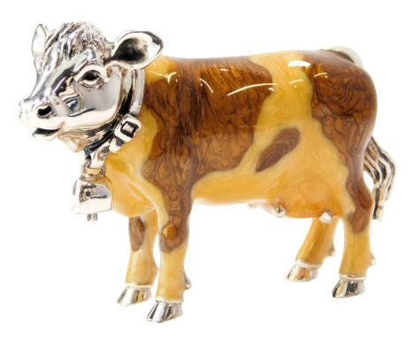 A silver and enamel figure modelled as a cow, wearing collar with bell, stamped 925, 5cm high. 