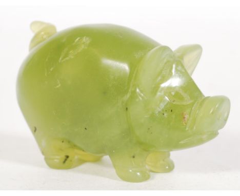 A Chinese carved green jade figurine of a pig having detailed features.&nbsp;Measures: 4cm high x 7cm wide.