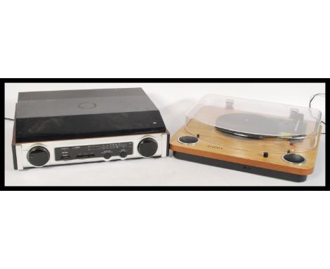 A contemporary record player by ION with built in speakers having a wood finish, together with another contemporary record de