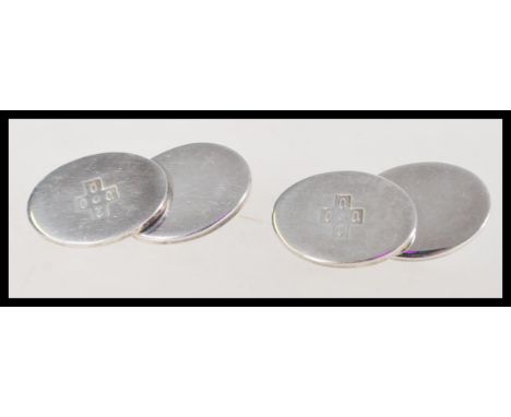 A pair of 20th century boxed silver cuff links marked 2000 onto an oval front face and chain fastenings, hallmarked 925 Birmi