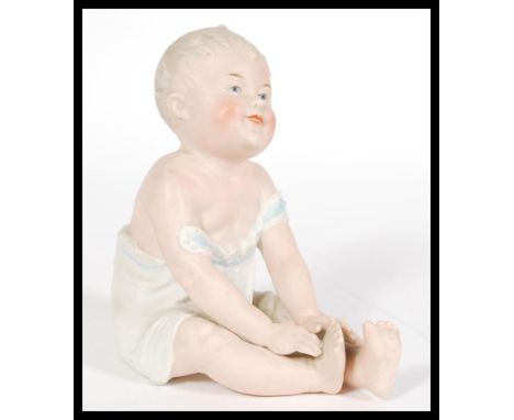 A 19th Century Continental bisque ceramic Piano Baby figurine, stamped 28 to the base, please see images for details. Measure