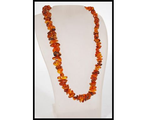 A 20th century vintage amber style resin necklace approximately 24 inches in length.&nbsp;Measures: 33cm long.