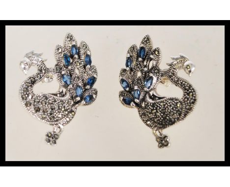A pair of vintage stud earrings in the form of peacocks with inset marcasites and sapphires.