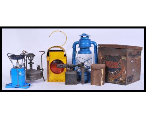 A group of vintage retro oil lamps and work lamps to include yellow enamel work lamp with red glass, Tilley lamp etc. Please 